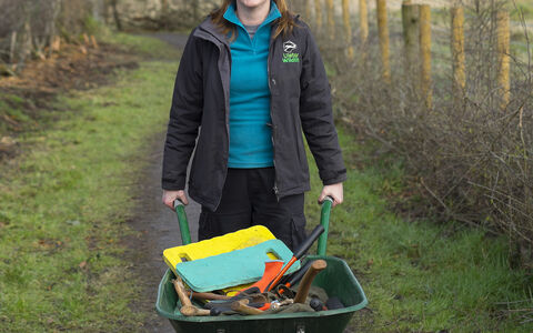 Deborah with a wheelbarrow on a nature reserve
